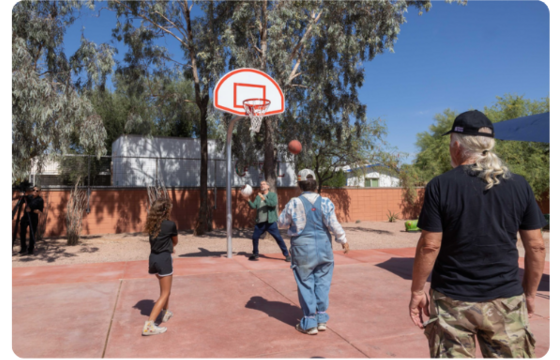 photo of Council Member Dahl playing basketball with Keeling neighborhood residents. Photo courtesy of Kathleen Dreier.