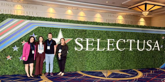 Casey Carrillo, Jacquelyne Vega, Heath Vescovi-Chiordi and Alma Peralta standing in front of a Select USA banner