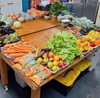 Photo of fruits and vegetables on a wooden table.