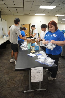 mdot volunteers packaging essentials to hand out to those in need