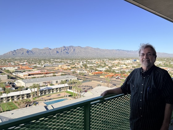 Council Member Dahl stands in front of a railing on a Tucson House balcony overlooking Ward 3