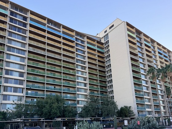 a view of Tucson House from the south showing the newly painted yellow, green, and blue balcony railings