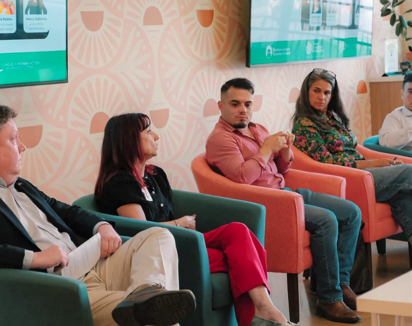 5 folks sit in chairs while participating in a community forum
