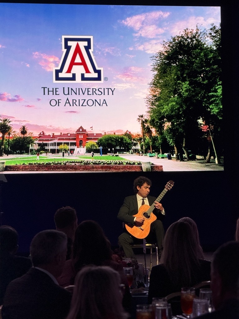 guitar student on a stage playing guitar