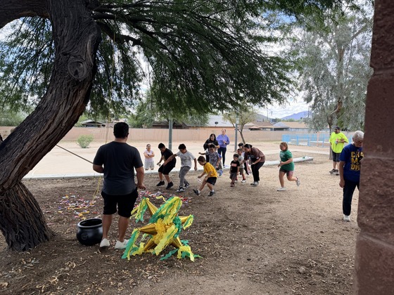 Kids running to collect candy after the pinata broke