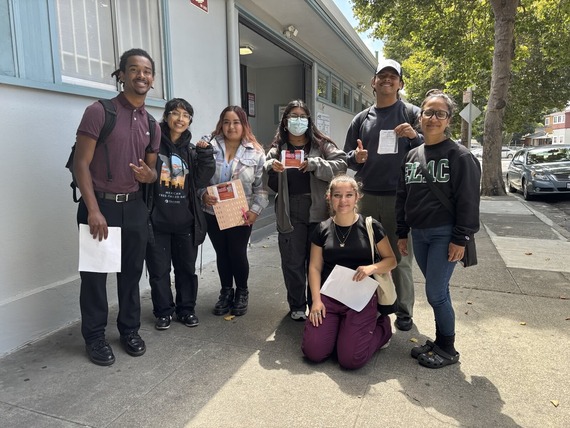 Kuzari (left) and Ixchel (front, sitting) doing street outreach with ACUDIR interns