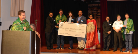 Supervisor Haubert and members of the Hindu Community & Cultural Center on stage with check from Alameda County.