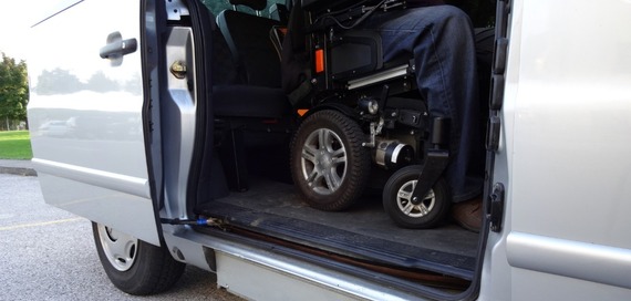 Photo of a wheelchair user inside a van with the side door open