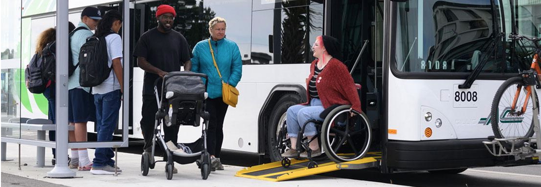 people with strollers, wheelchair, and on foot getting of a bus