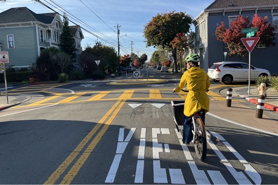 Photo of intersection of Pacific and Oak with traffic circle and bicyclist 