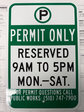 Sign saying Permit ONly - Reserved 9-5 Monday-SAturday 