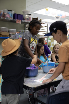Group of kids at a table doing an art project