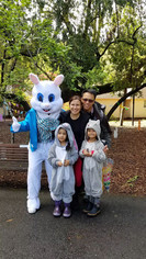 Person in a rabbit costume posing with a family in a squirrel and bunny costume