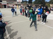 Group of children playing a game on a paved court