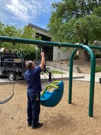 Parks staff installing ADA swing