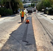 Workers repairing pavement on Laurel Avenue
