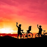 Cyclists looking at a sunset