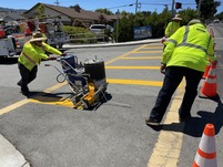 Public Works staff applying thermo-plastic striping to crosswalks