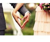 photo of two people holding hands in a shape of a heart