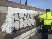 Staff cleaning graffiti 