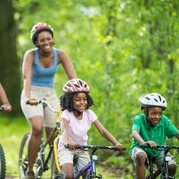 Three people riding bikes