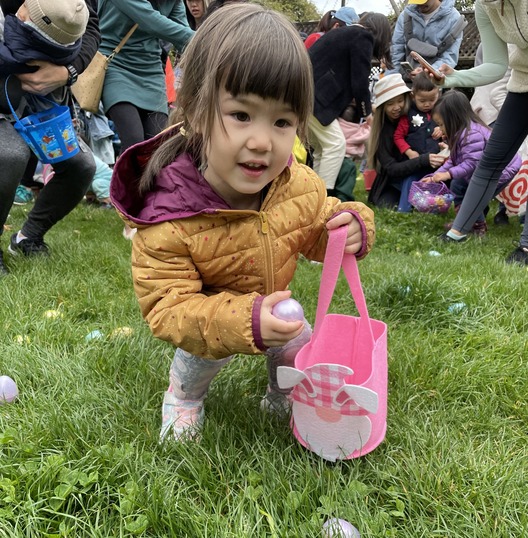 Photo of child at the egg hunt searching for eggs