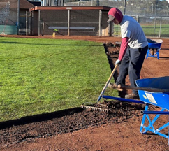 Person maintaining a baseball field