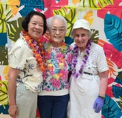 Three people at a themed senior event.