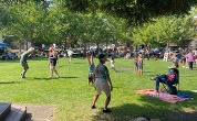 People standing in the park during the summer concert series