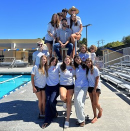 Group of lifeguards posing by the pool