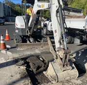 Public works crew excavating for asphalt repair. 