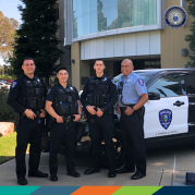 Four police officers in front of city hall.