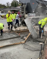 Crews pouring concrete to make ADA ramp