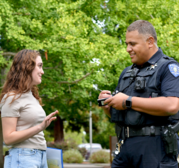 Police Officer speaking to a resident at a park 