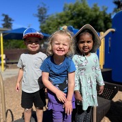 3 Children Smiling at Belmont Community Learning Center
