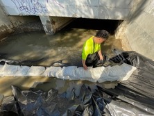 Staff building a dam for bypass system