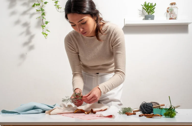 A woman wrapping gifts sustainably with cloth wrapping paper
