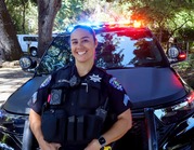 Officer standing in front of a police car