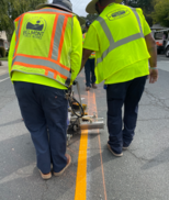 Crews painting the yellow lines on the roadways