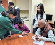 Volunteers teaching at tech support session