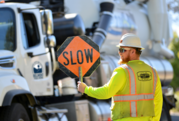 Crews guiding traffic at worksite 