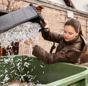 Someone putting shredded paper in recycling