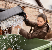 woman recycling shredded paper