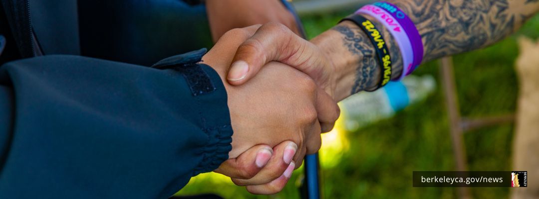 Two people shake hands