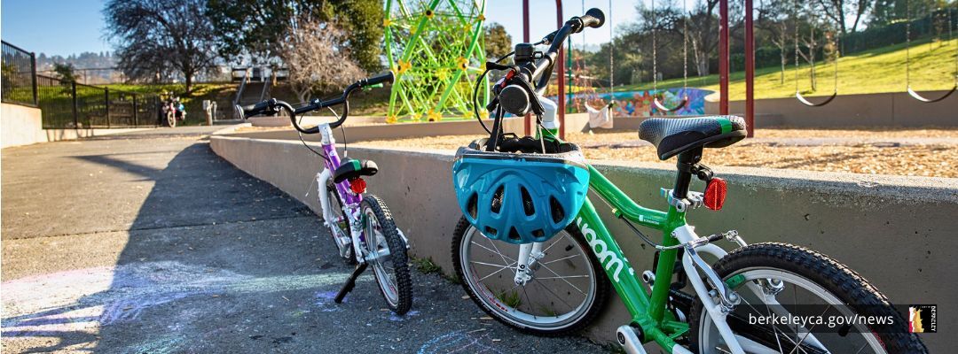 Bikes lined up next to wall by a Berkeley playground