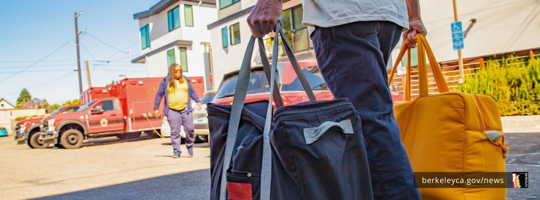 Person carrying large bags in a parking lot