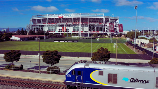Train in front of football stadium