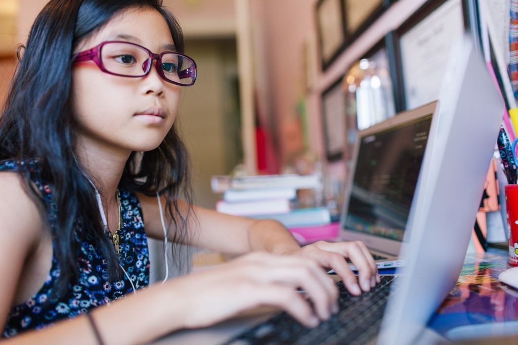 young girl looking at a computer