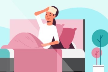 Person in bed at home with fever holding cloth to forehead.