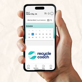 hand holding phone with recycle coach app on screen
